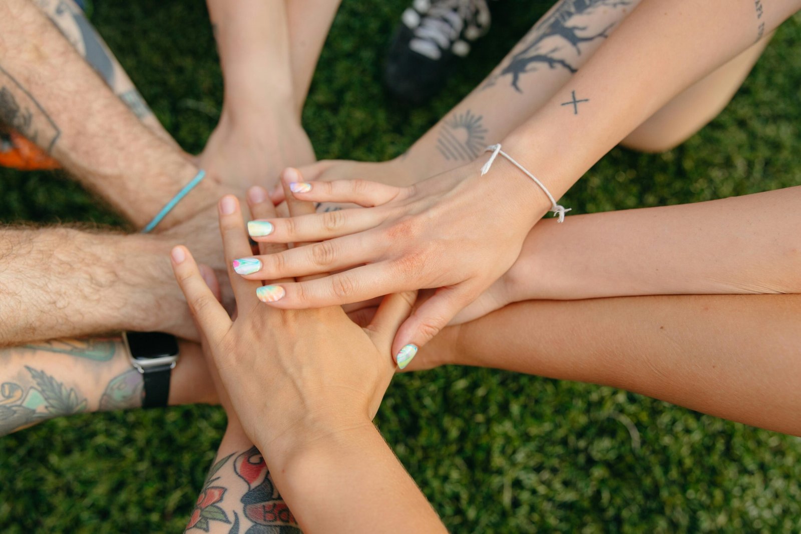Close-up of diverse hands joined together in solidarity, representing Peaceful Social Justice Activism and unity across communities.